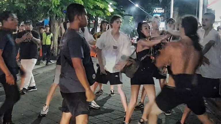 Schoolies push each other after one of the girls was hit in Bali.