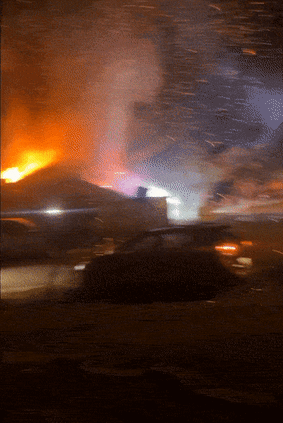 A nearby resident defends their home after an underworld firebombing causes embers to rain down on Craigieburn.