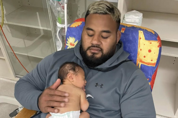 Taniela Tupou and his newborn son Nela.