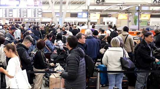 Passengers queue at Jetstar Airways’ check-in area at Sydney Airport in 2024.