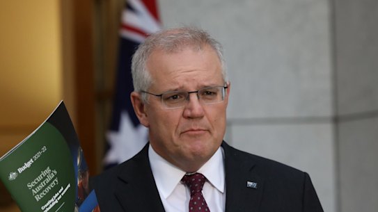 Treasurer Josh Frydenberg is congratulated by Prime Minister Scott Morrison after delivering his budget speech in the House of Representatives at Parliament House in Canberra on May 11, 2021. fedpol Photo: Dominic Lorrimer