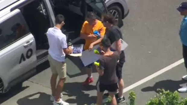Novak Djokovic signs autographs for fans at Essendon Airport on Monday.