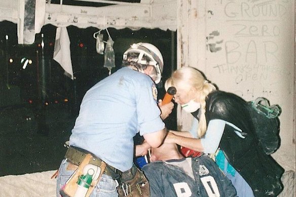 Alison Thompson washing out a firefighter’s eye with saline during the aftermath of September 11.