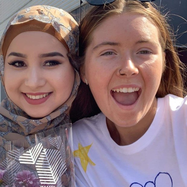 Ruqia Haidari, left, and Abbey Gawne, right,  during their graduation at McGuire College in Shepparton.