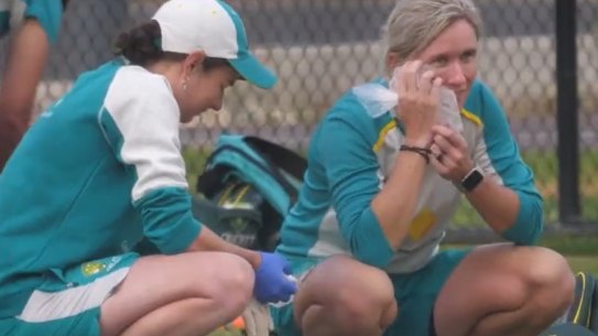 Beth Mooney puts ice on her face after getting hit on the jaw.