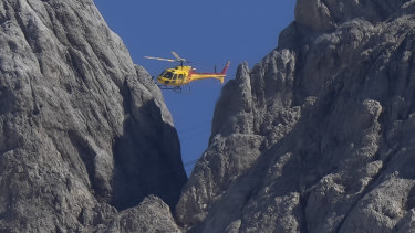 A rescue helicopter hoovers over the Punta Rocca glacier near Canazei in the Italian Alps on Monday.