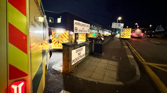 Ambulances queue outside of a hospital in England.