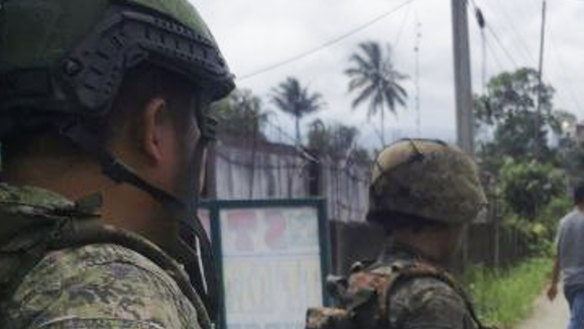 Filipino troopers man a checkpoint near the site where a bomb exploded in Marawi, southern Philippines.