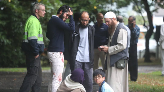 Stunned and bloodied workshippers outside one of the Christchurch mosques.