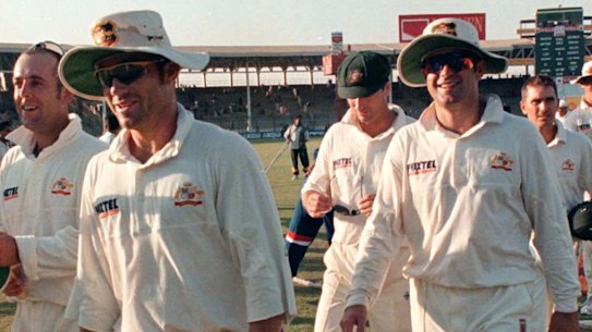Australian cricketers walk from the field after drawing the third Test against Pakistan in Karachi, 1998.