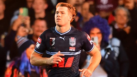 NSW Blues 18th man Matt Burton runs out for Origin I in Adelaide.