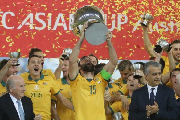 Mile Jedinak holds aloft the 2015 Asian Cup trophy - the Socceroos' finest achievement.