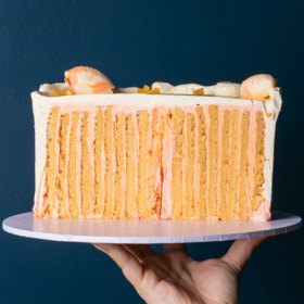 Zesty citrus layer cake created by rolling cake sponge like a Swiss roll.
