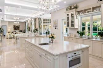 The palatial kitchen/living/dining room benefits from exceedingly tall ceilings. 