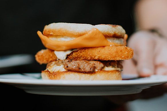 Warkop’s breakfast muffin served with a house-made sausage patty, fried egg, optional hash brown (pictured) and “Bazzinga sauce”.