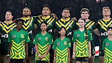 Kangaroos players stand together for the national anthem.