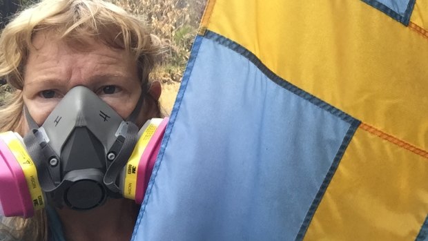 Helena Brandfors, at her house in Leilani Estate, protects herself from toxic fumes from the erupting Kilauea.