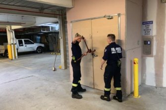 Firefighters use bolt cutters during an inspection of the Auburn apartment complex in late 2019.