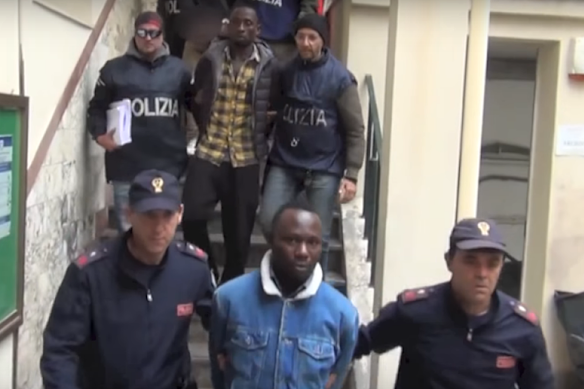 Suspected members of Black Axe being rounded up in Italy in 2018. 