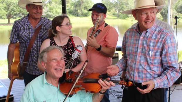 Texas Governor Greg Abbott plays the fiddle as the state’s coronavirus cases surge.