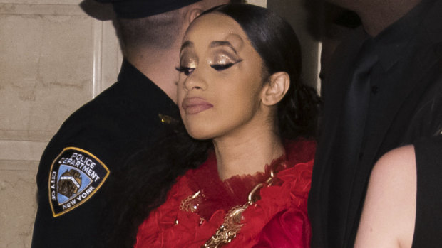 Cardi B, with a bump on her forehead, leaves after an altercation at a Harper's Bazaar party.