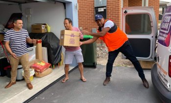 Amit Thapa (right), founder of the Friends of Nepal Association, gives a helping hand.