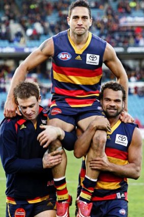 Andrew McLeod, pictured being chaired off the ground after his 300th game, now feels he's not welcome. 