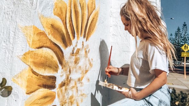 Holly Ogden paints sunflowers for free all over Perth.