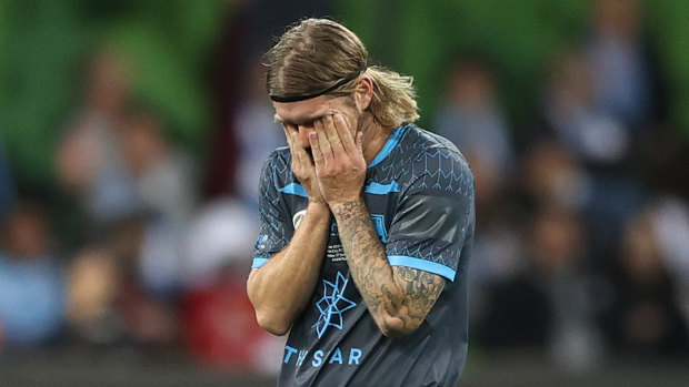 Luke Brattan trudges off the pitch after being sent off.