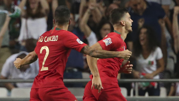 Victory: Portugal's Andre Silva (right) celebrates his goal against Italy.