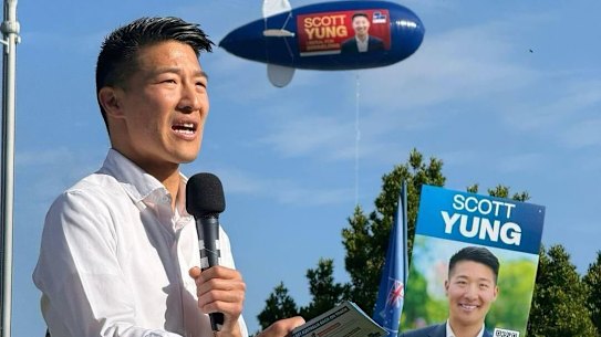 Scott Yung speaking during the federal election campaign, with an advertising blimp hovering overhead.