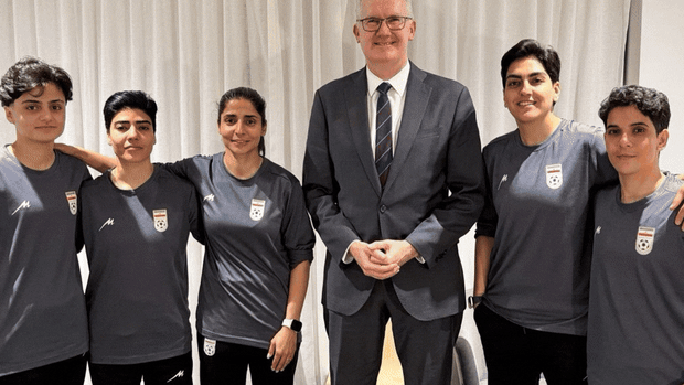 Home Affairs Minister Tony Burke with the five Iranian soccer players who were granted visas.