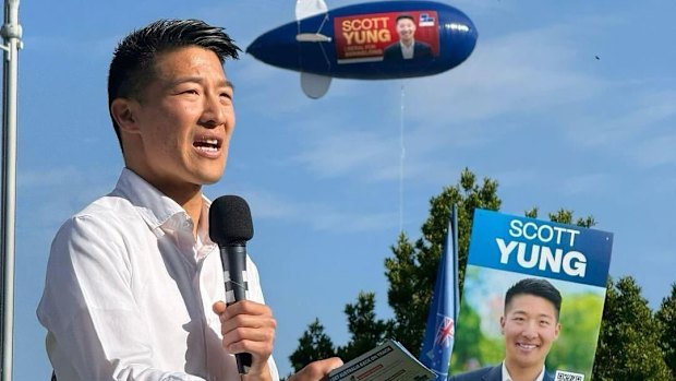 Scott Yung speaking during the federal election campaign, with an advertising blimp hovering overhead.