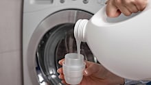 Laundry detergent being poured into a cap.