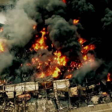 Firefighters on platforms battle the West Footscray factory fire of August 30, 2018. 