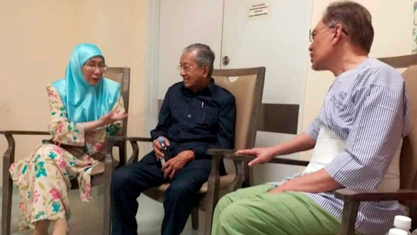 Anwar Ibrahim, right, Mahathir Mohamad, middle and Anwar's wife, Wan Azizah, at the hospital in Kuala Lumpur.