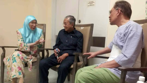 Anwar Ibrahim, right, Mahathir Mohamad, middle and Anwar's wife, Wan Azizah, at the hospital in Kuala Lumpur.