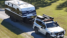 An SUV towing a caravan made by Essential Caravans.