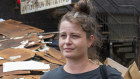 Betty Russ, outside the Elevator ARI in Lismore, where water covered the first floor windows. 