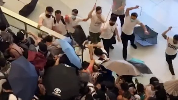 Men wearing white shirts were filmed wielding rods and beating demonstrators at Yuen Long MTR station in Hong Kong on Sunday.