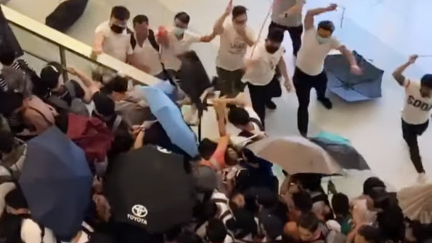 Men wearing white shirts were filmed wielding rods and beating demonstrators at Yuen Long MTR station in Hong Kong on Sunday.