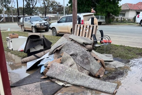 Destroyed carpet and furniture outside the flooded St Joseph’s Catholic Primary School in Rochester. 