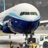 Boeing employees and family members cheer the 777X after it landed at Boeing Field in Seattle, completing its first flight on Saturday, Jan. 25, 2020. (Mike Siegel/The Seattle Times via AP)