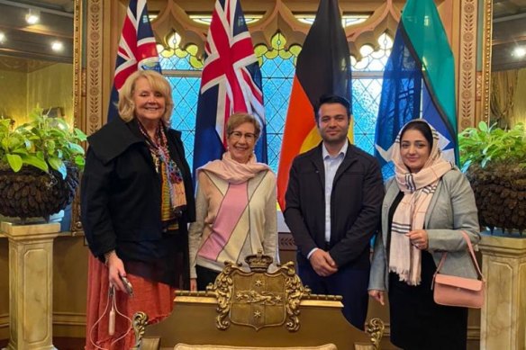 Judge Robyn Tupman (left), who is helping evacuate female judges from Afghanistan, with Nellab (at right) and her husband, Malyar, at an afternoon tea with NSW Governor Margaret Beazley.