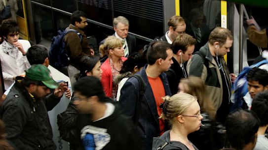 Commuters crowd to board a train at Town Hall.