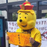 Chinese international student Aaron dressed as Winnie the Pooh as part of his protest against Chinese president Xi Jinping at a bus stop outside the entrance to the University of Sydney in February 2023.