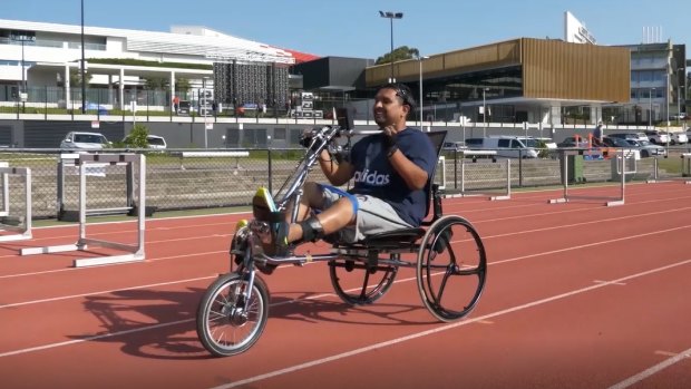 Dr Palipana, a quadriplegic, riding a bike using the BioSpine.