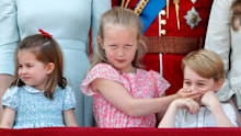 Catherine, Duchess of Cambridge, Princess Charlotte, Prince William and Savannah Phillips (with her hand over Prince George's mouth) stand on the balcony of Buckingham Palace during Trooping The Colour 2018 on June 9, 2018 in London, England.