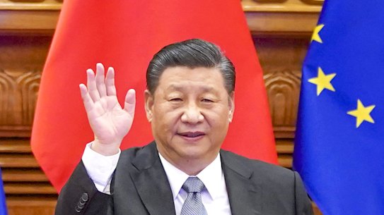 Chinese President Xi Jinping waves during a video conference with European leaders.