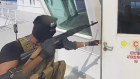 A photo released by the Houthi Media Centre shows a Houthi gunman on the cargo ship Galaxy Leader on November 19.